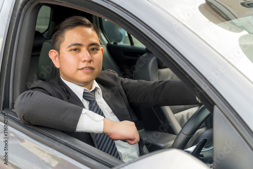 Young asian man wearing suit driving car © faizzaki