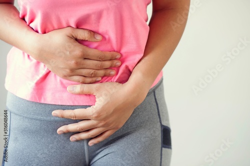 Wallpaper Mural Close-up of a pink lady with a lot of menstrual cramps in the bedroom. Torontodigital.ca