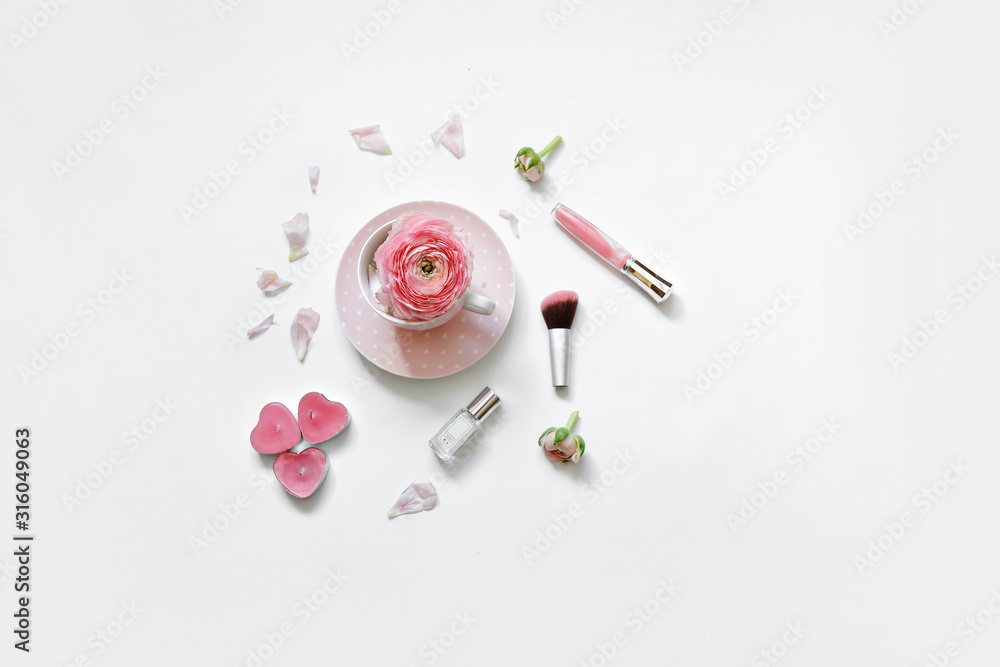 Styled feminine flat lay on white background, top view. Romantic still life - cup of tea, rose petals, perfume, makeup brush and candle in the shape of a heart. Time for morning tea Styled feminine flat lay on white background, top view. Romantic still life - cup of tea, rose petals, perfume, makeup brush and candle in the shape of a heart. Time for morning tea