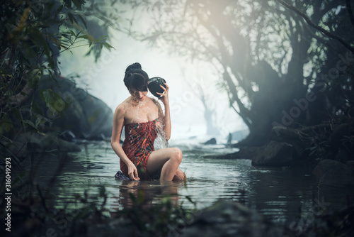 Asian sexy woman bathing in cascade Thailand