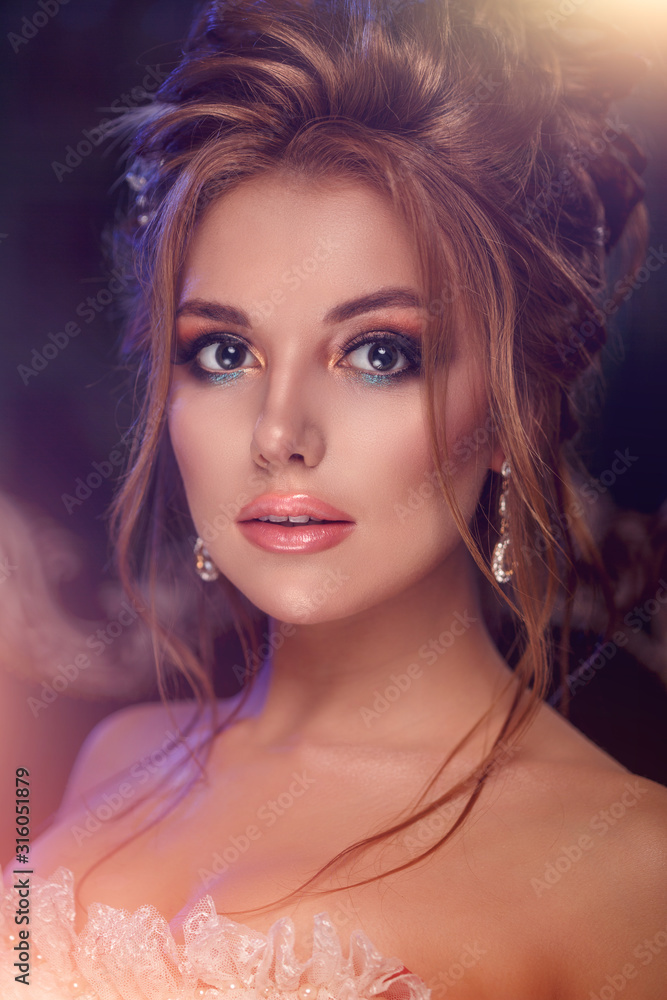 Luxury model in vintage style. Beautiful woman with a stunning hairstyle and make-up in a rococo dress. Girl at the Masquerade Spring Ball