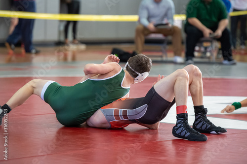 High School wrestlers competing at a wrestling meet photo