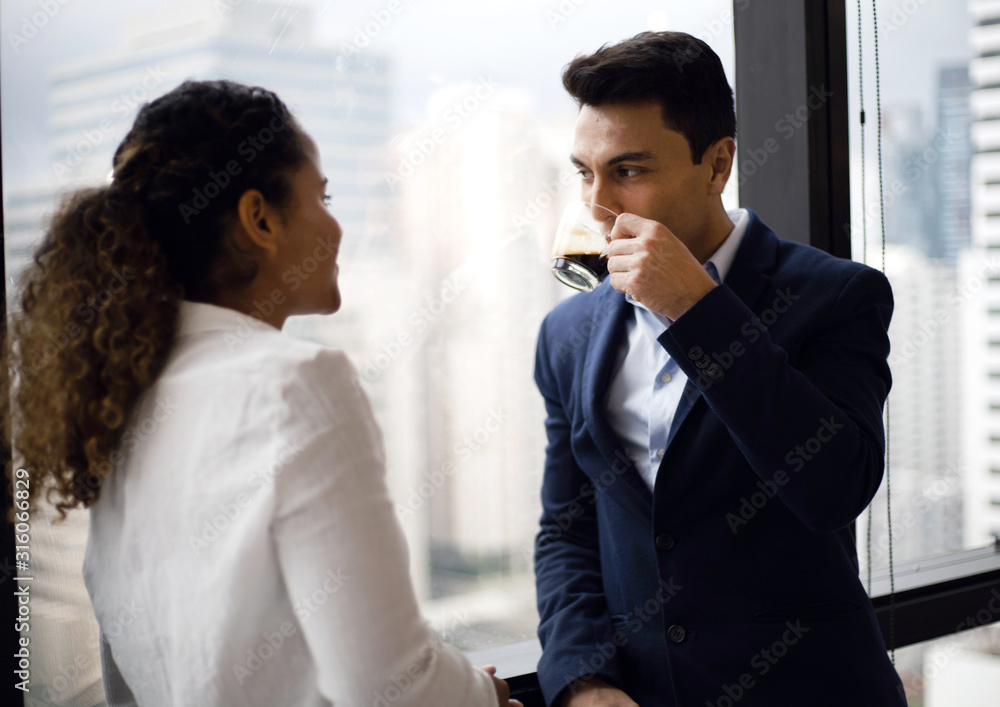 Two business persons talking and meeting in break time at office.