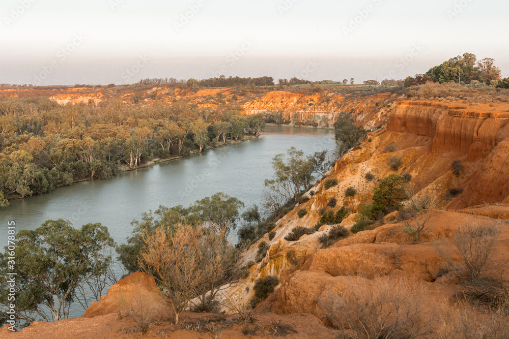 Scenic view to Murray River from rugged cliff top at Murtho lookout in Riverland. Natural South Australian waterfront scenery in Riverland at sunset
