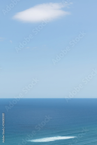 Aerial view of calm Tasman sea with white cloud and white patch on water in day light