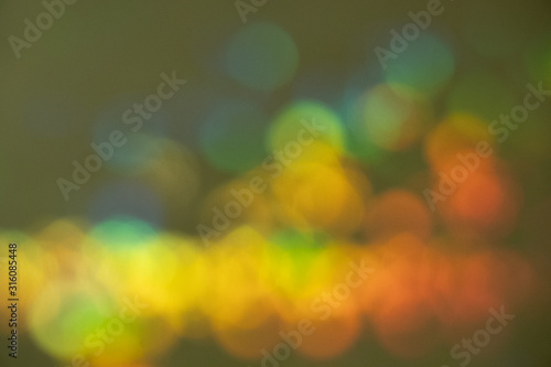 Blurred holiday colorful background with star-shaped highlights.