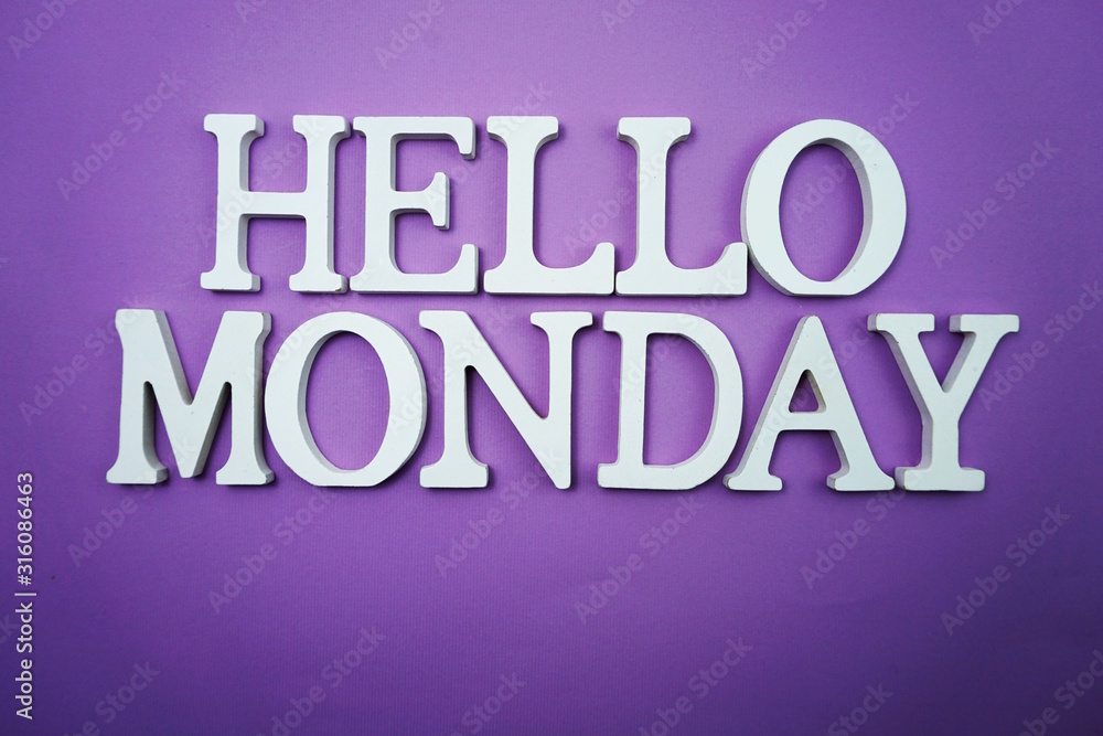Hello Monday wooden letter alphabet on purple background Hello Monday wooden letter alphabet on purple background