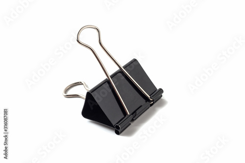 Black metal binder clip on white background isolated.