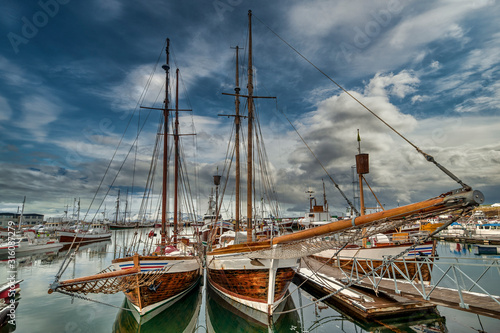 Sailboats in the port of Husavik. Beautiful view of the historic town of Husavik. photo