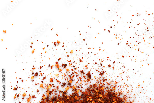 Crushed red cayenne pepper, dried chili flakes isolated on white background, Top view. © Janthana
