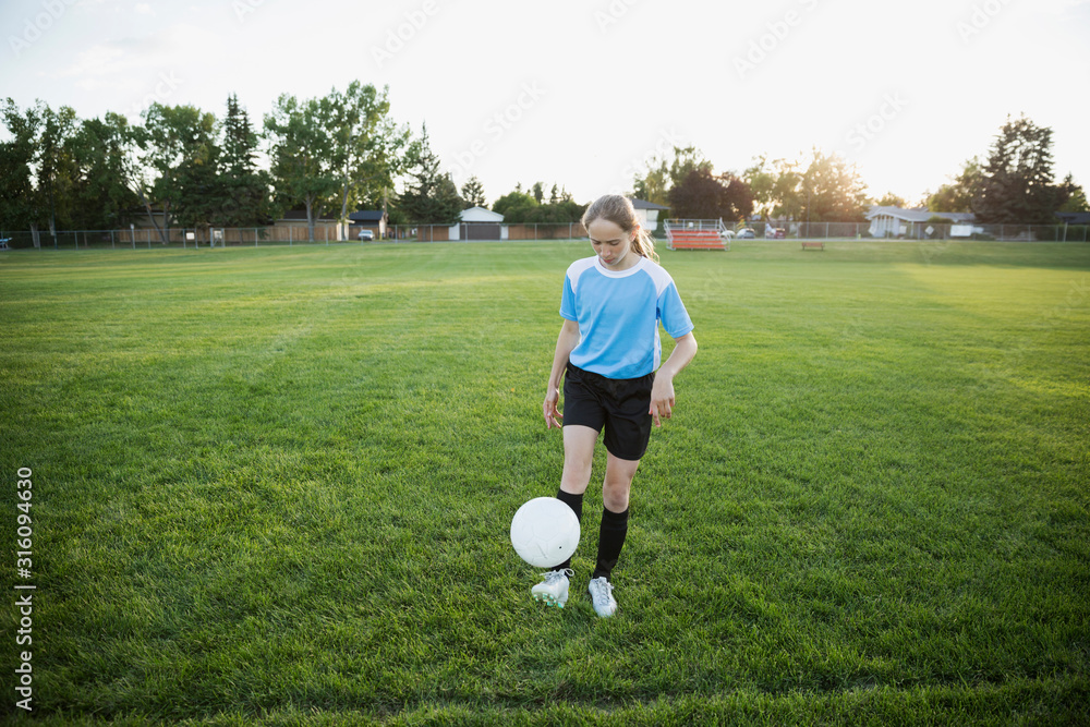 Girl juggling store soccer ball