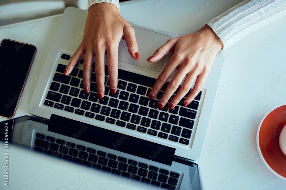 Close up of female hands on laptop typing Close up of female hands on laptop typing