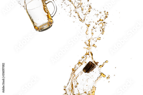 transparent mug with black tea turned upside down and falls with a splash and spray