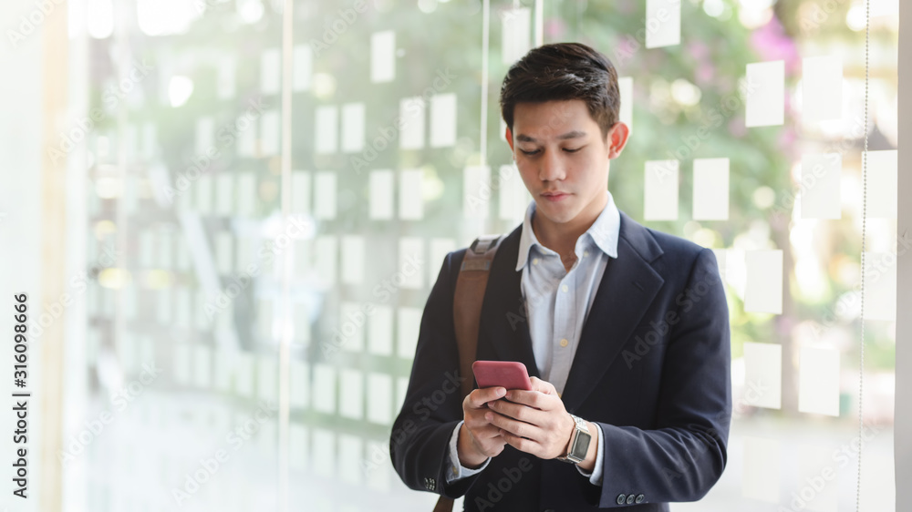 Close up view of young professional businessman typing on smartphone Close up view of young professional businessman typing on smartphone