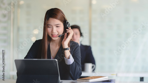 Close up view of female customer service talking on headset with smiling