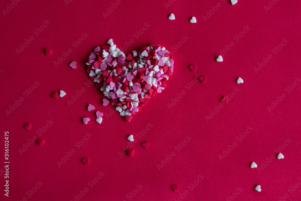 Pink and white and red hearts on a red background in the form of a heart. Lots of Little Sweet Hearts, Valentine's Day or Mother's Day