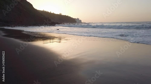 Wallpaper Mural Huge atlantic ocean waves slowly covering wide beach with volcanic sand during sunset at Tenerife, Canary Torontodigital.ca