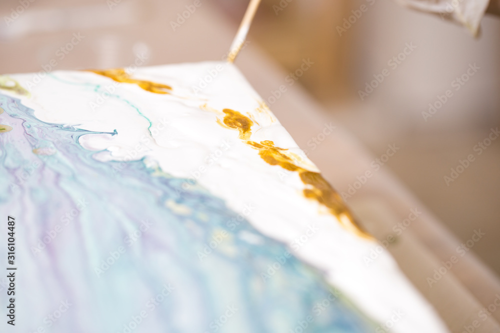 The girl creates a picture with abstraction in bright colors. The girl creates a picture with abstraction in bright colors.