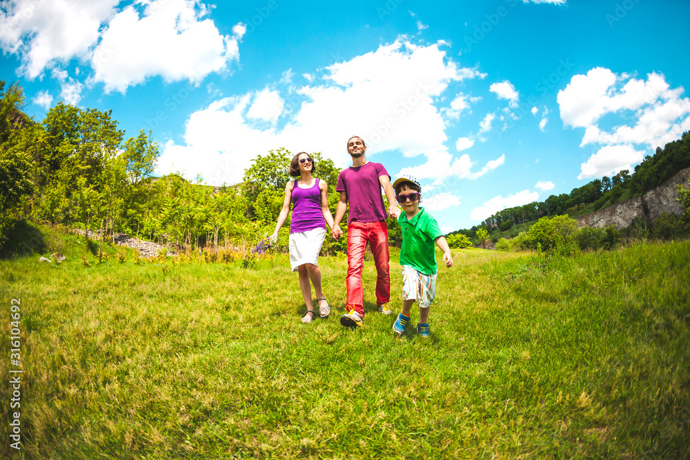 Fototapeta premium Family walking in a meadow.