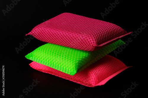 Set of colorful dish washing sponges at black background