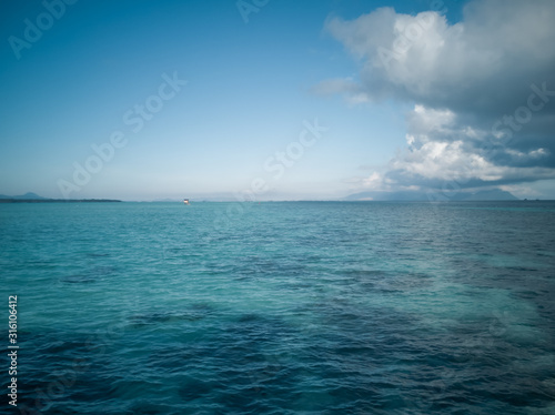 wide panorama of sea against sky at the tropical island in Semporna, Borneo Sabah, Malaysia.