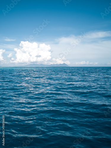 wide panorama of sea against sky at the tropical island in Semporna, Borneo Sabah, Malaysia. © ellinnur