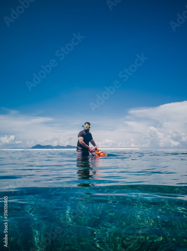 People in snorkeling mask dive underwater with tropical fishes in coral reef sea pool. Travel lifestyle, water sports, outdoor adventure, swimming family summer beach holiday with kids © ellinnur