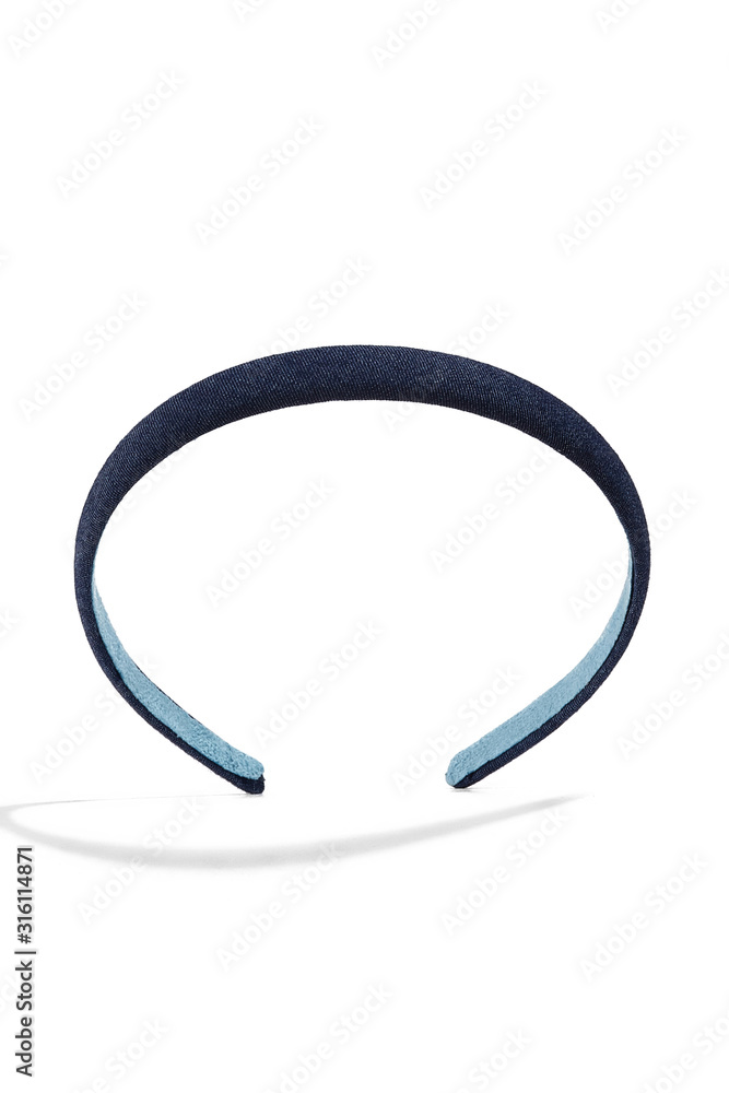 Subject shot of a tight hairband covered with a deep blue denim fabric. The stylish headband is isolated on the white background with shadows. Subject shot of a tight hairband covered with a deep blue denim fabric. The stylish headband is isolated on the white background with shadows.