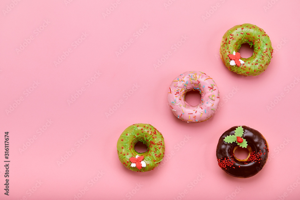 Sweet donuts of different colors, on a pink background. Copy space, blue and pink backgrounds Sweet donuts of different colors, on a pink background. Copy space, blue and pink backgrounds