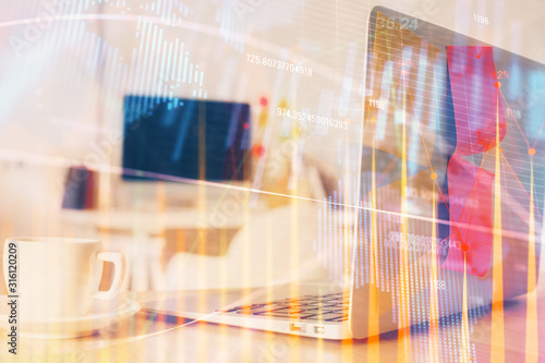 Stock market graph on background with desk and personal computer. Multi exposure. Concept of financial analysis.