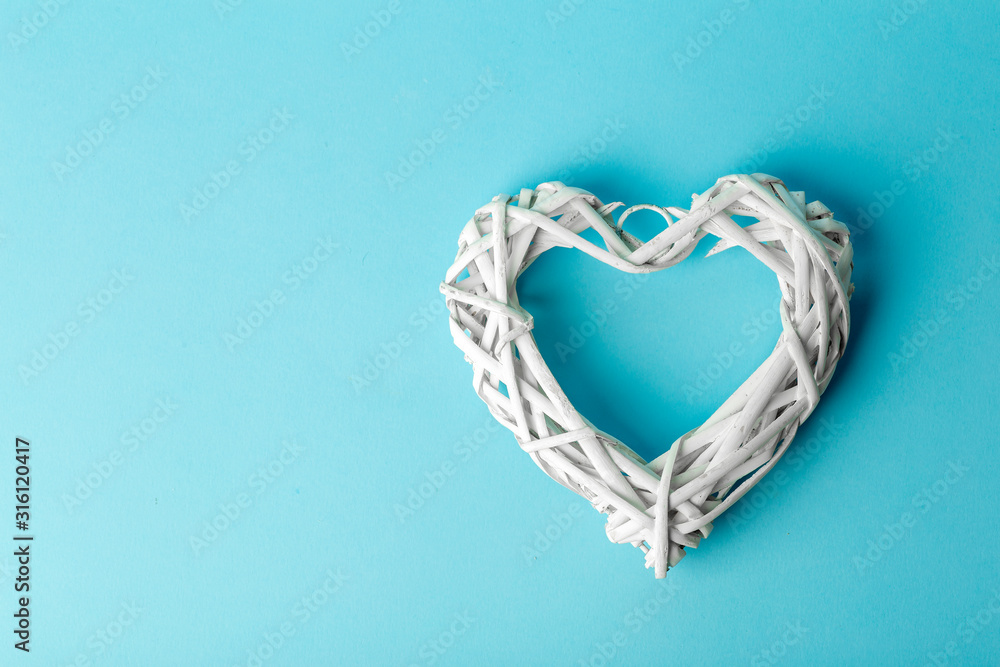 Fototapeta premium Love (Valentine's day) background or wedding background. White heart on a blue pastel background. Love concept