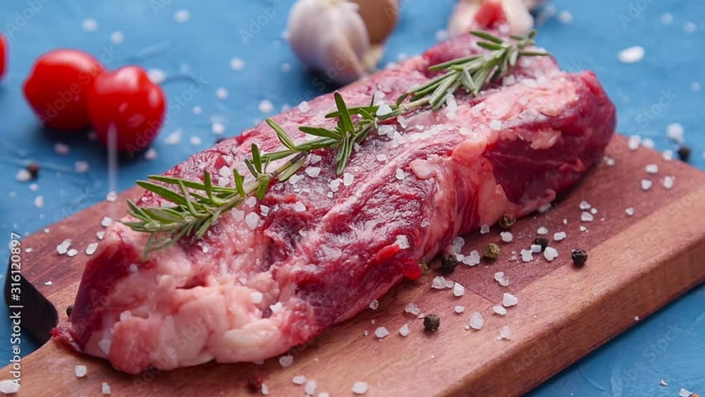 Raw fresh meat Steak with herbs and spices on rustic background Raw fresh meat Steak with herbs and spices on rustic background