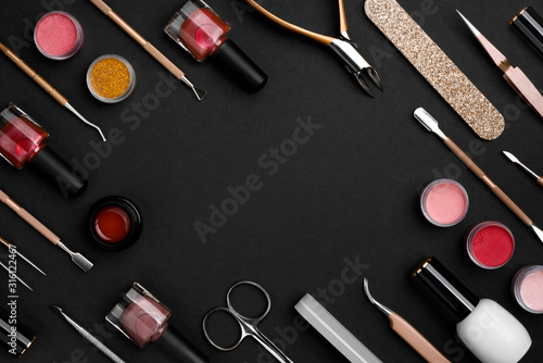 Various manicure or pedicure tools and accessories on dark background photo