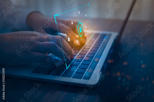 Businessman using a laptop computer with technology cybersecurity and privacy concept. protection and safe data for global network security.