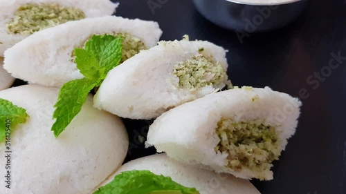 Traditional Indian Idlis comes with a twist. With Chicken stuffing. Garnished with fresh mint leaves.