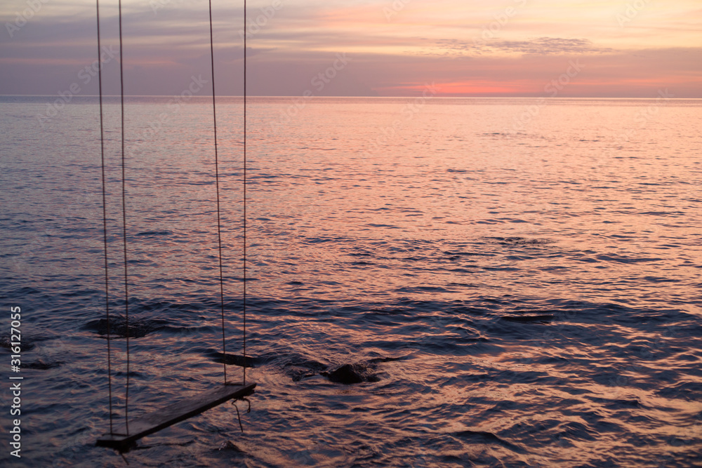 Swing at the beach on sea sunset background Swing at the beach on sea sunset background