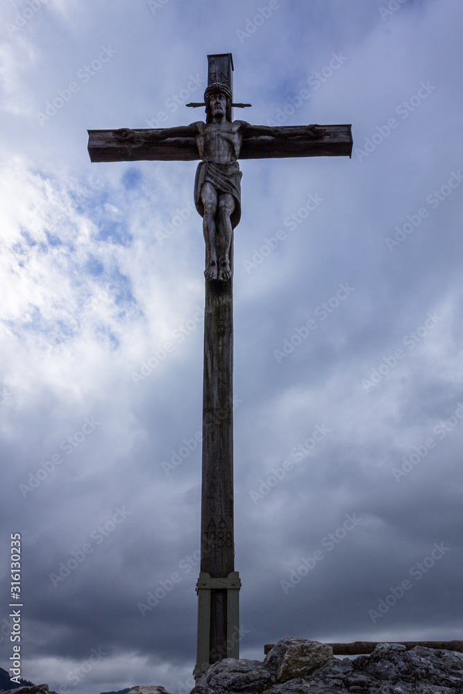 Summit Cross on Peak of Mount Kofel, 1342 m in Ammergauer Alps, Ostalpen, located in Oberammergau, Upper Bavaria, Germany