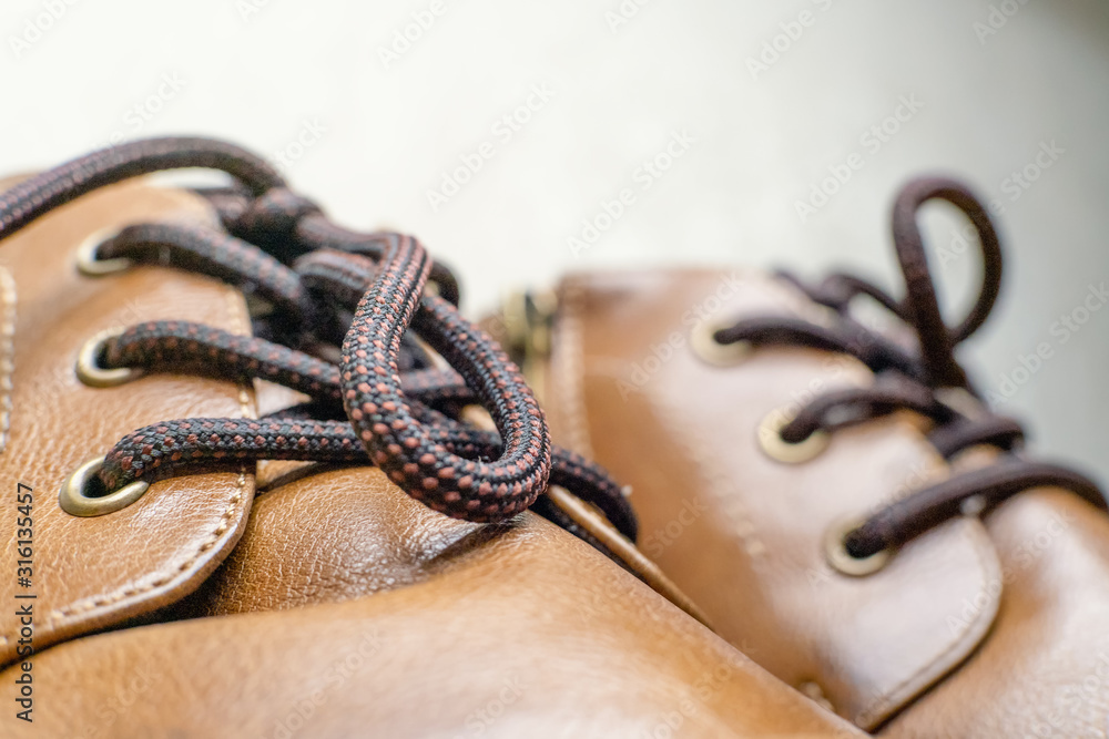 Close-up of laces on brown leather shoes, background
