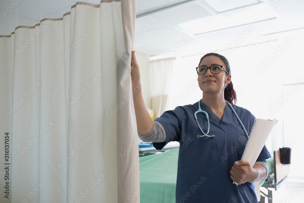 Female nurse closing hospital curtain Photos Adobe Stock