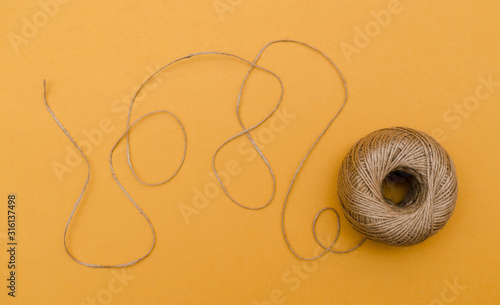 Hemp cord, jute twine on yellow paper backgound