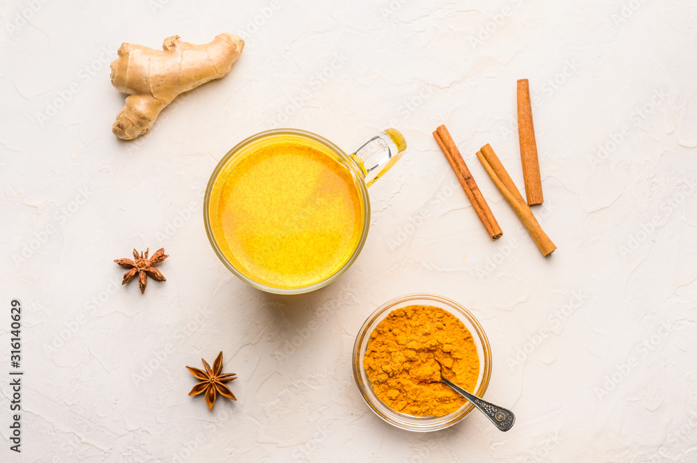 Cup of traditional indian masala chai tea with ingredients above over white texture background Cup of traditional indian masala chai tea with ingredients above over white texture background