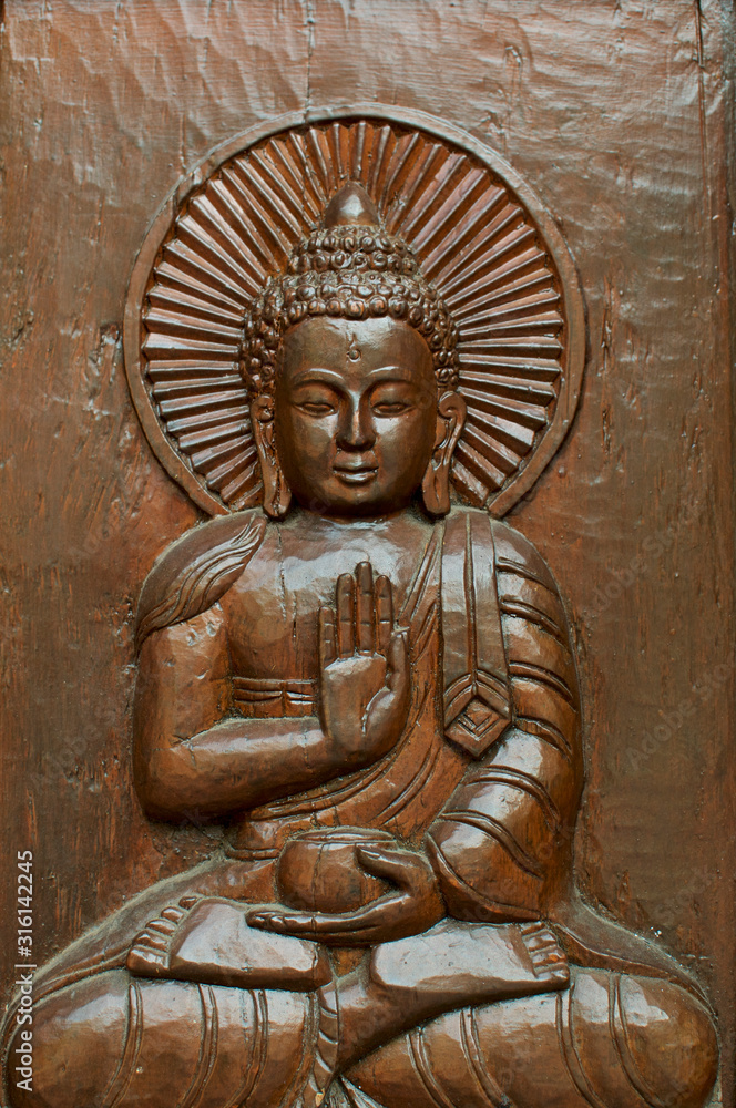 Beautiful in wood carved Buddha figure