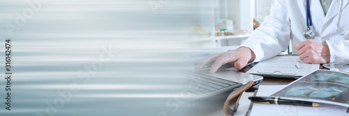 Doctor using a laptop; panoramic banner