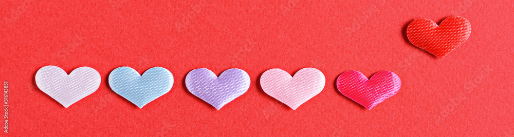 small multicolored hearts in row on red background for banner small multicolored hearts in row on red background for banner