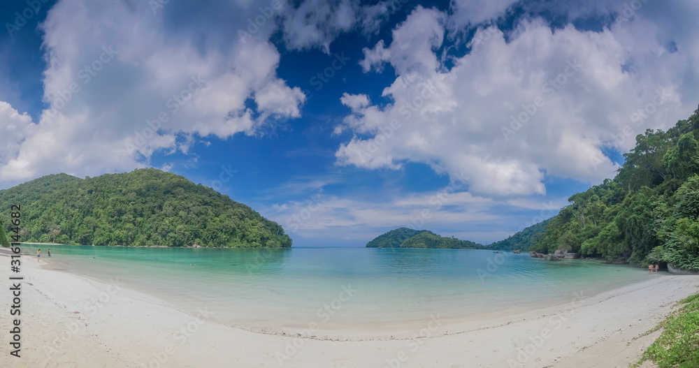 view seaside of white sand beach with blue-green sea with green forest and blue sky background, Surin island, Mu Ko Surin National Park, Phang Nga, southern of Thailand.