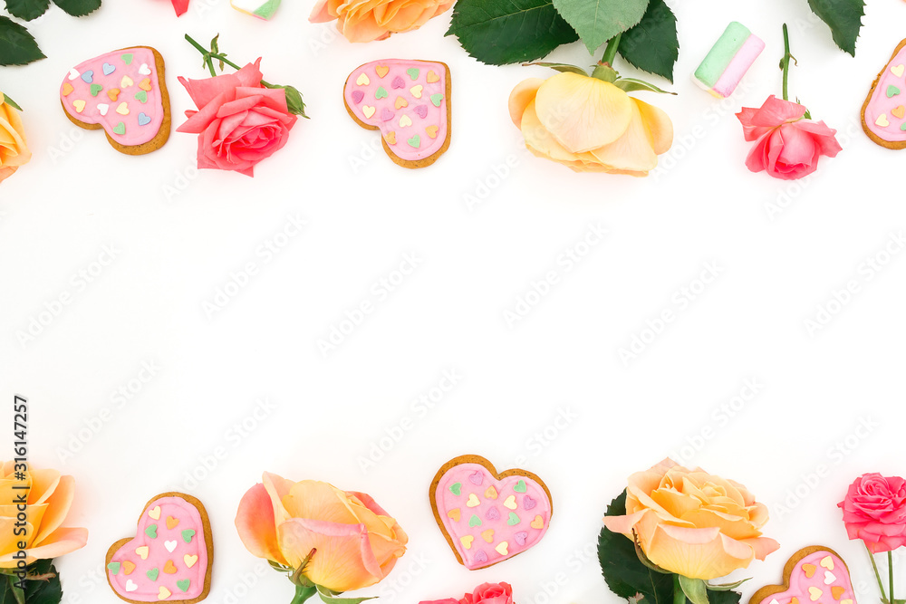 Frame with roses flower and cookies on white background. Flat lay. Valentines day Frame with roses flower and cookies on white background. Flat lay. Valentines day
