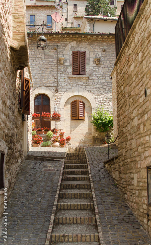 A medieval picturesque street with staircase in Assisi, Italy