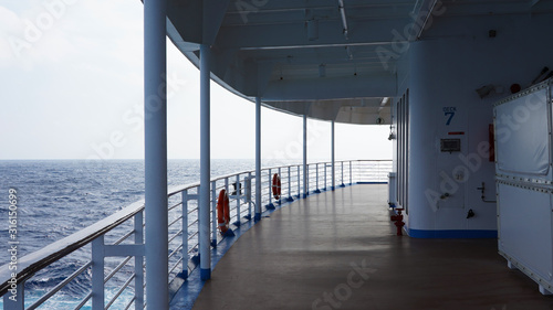promenade deck on a cruise ship. safety on the ship, lifeboat, liferafts, lifebuoys. liferaft station. blue ocean. white ship in the blue ocean. large cruise ship    © Artem