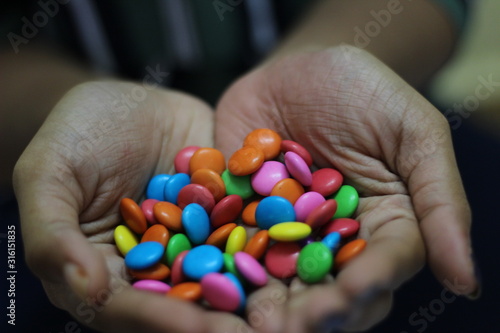Wallpaper Mural hand full of candies Torontodigital.ca
