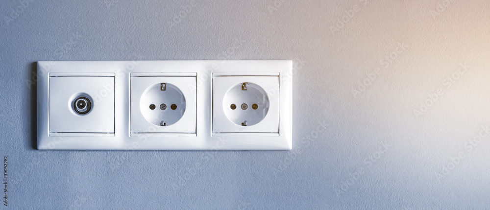 electrical outlets, a set of three white empty electrical sockets and an antenna connector for a TV on an empty gray, banner with copy space electrical outlets, a set of three white empty electrical sockets and an antenna connector for a TV on an empty gray, banner with copy space